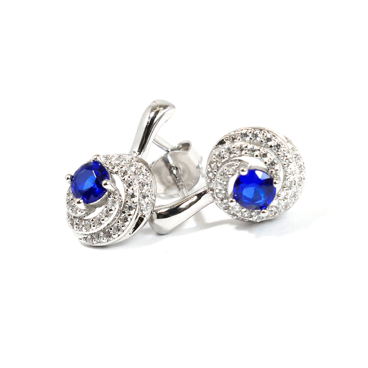 Silver earrings with blue gemstones on a white background