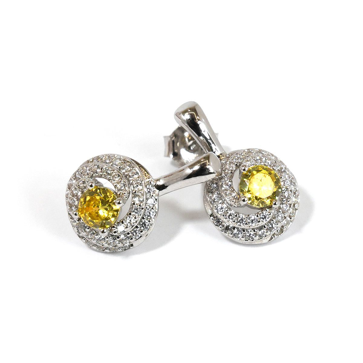 Pair of silver earrings with yellow gemstones on a white background