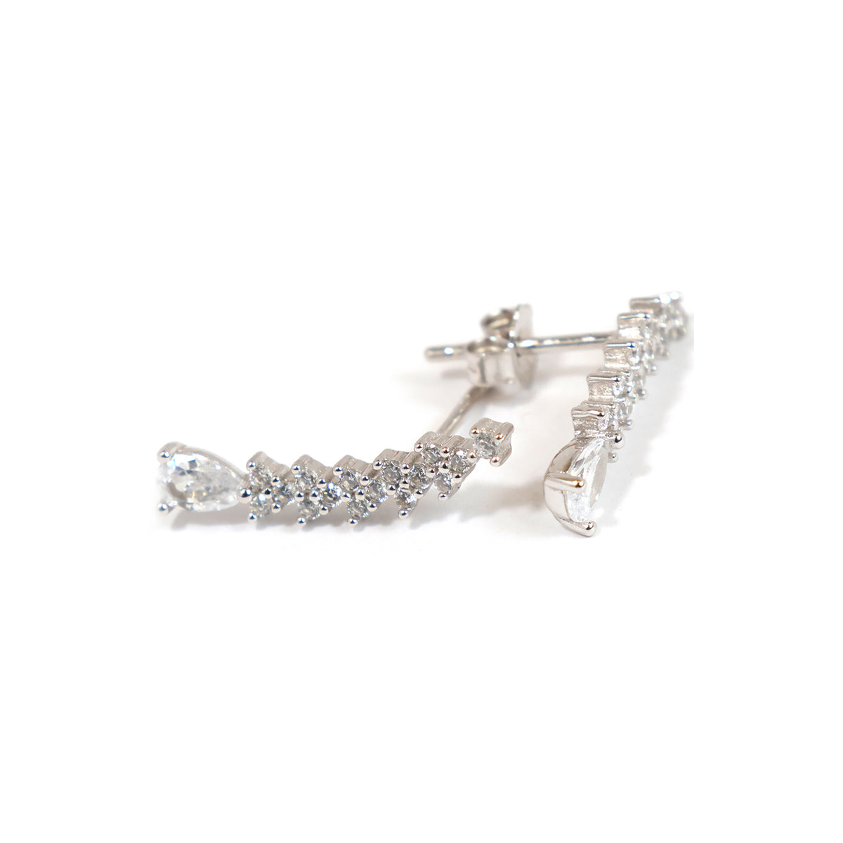 Pair of silver earrings with clear stones on a white background