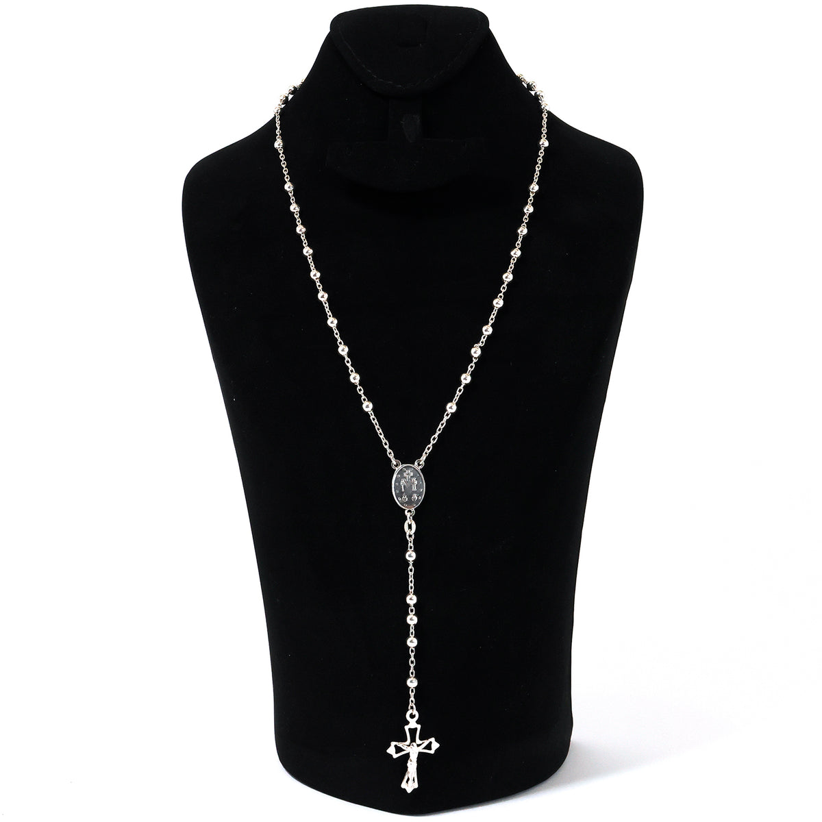 Silver necklace with a cross pendant on a black mannequin against a white background