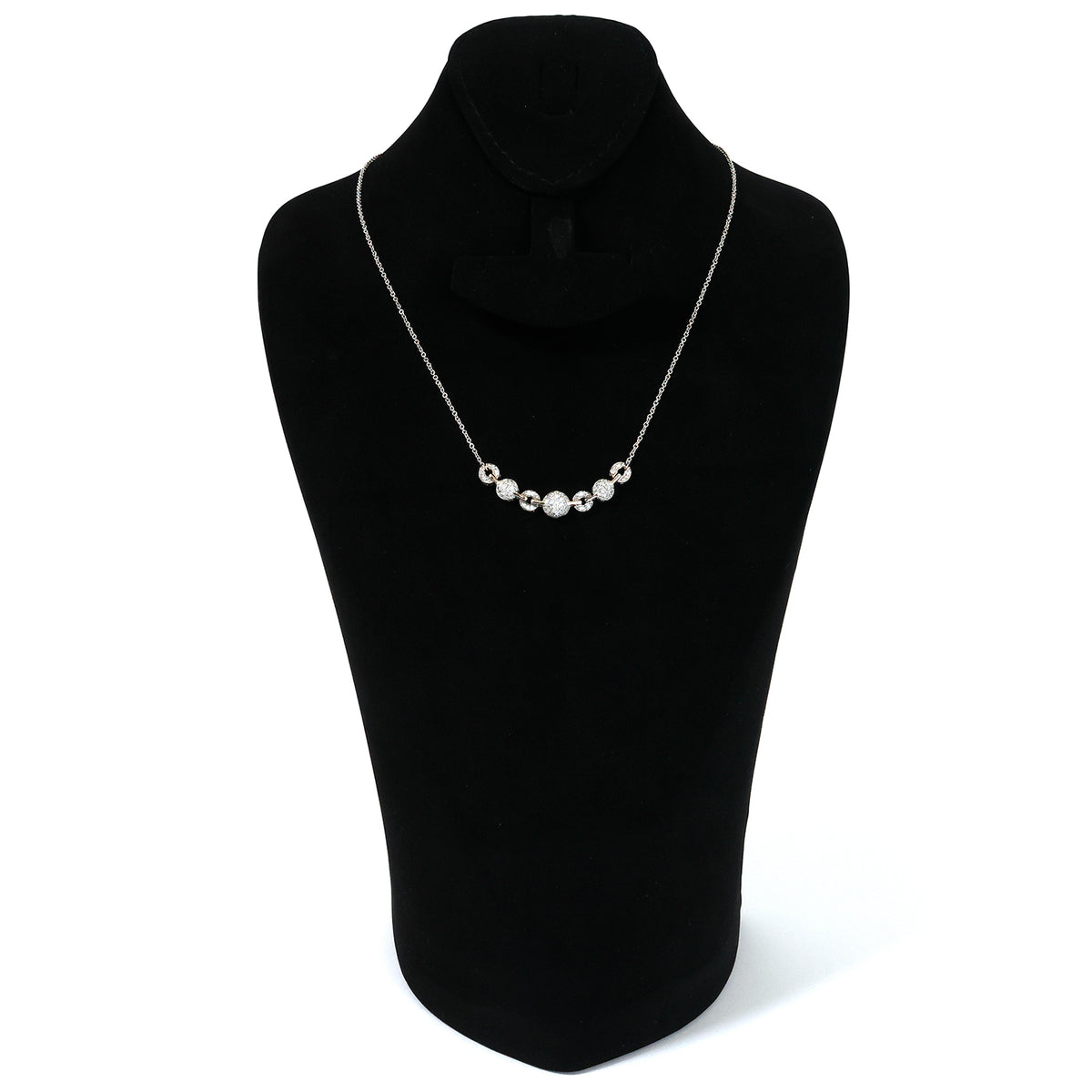 Pearl necklace on a black mannequin bust against a white background