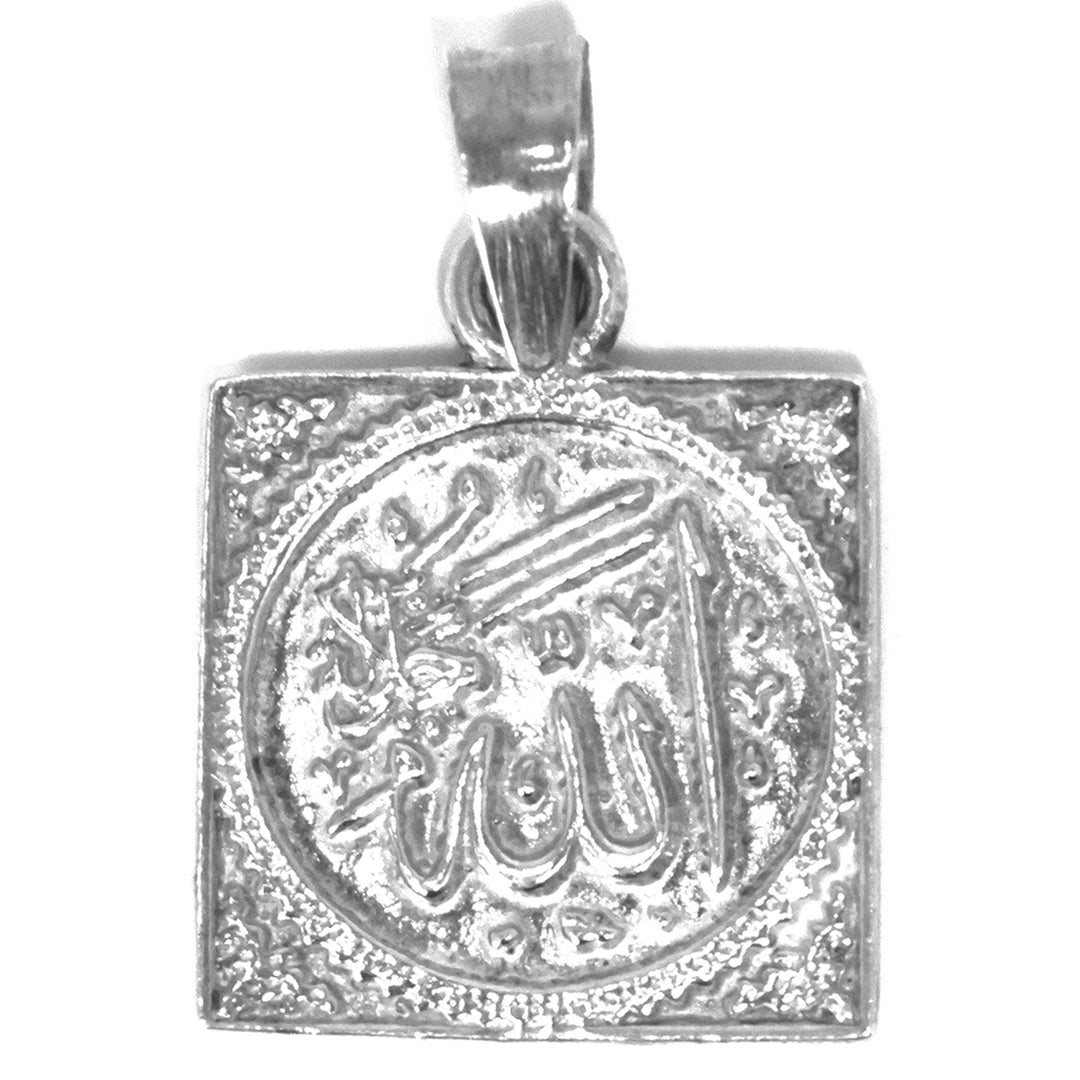 Silver pendant with engraved design on a white background