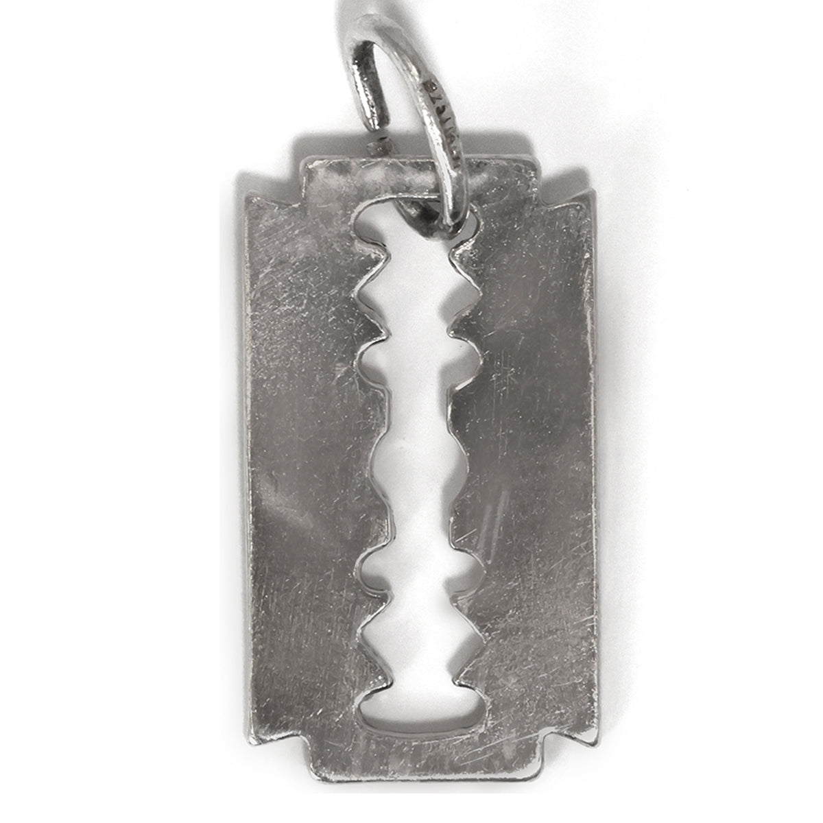 Silver pendant shaped like a razor blade on a white background