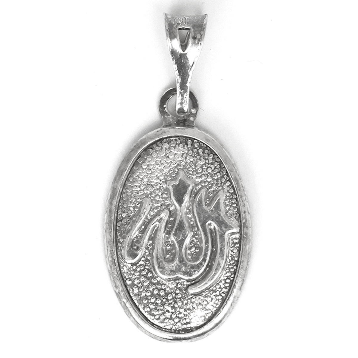 Silver pendant with engraved design on a white background
