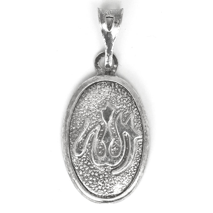 Silver pendant with engraved design on a white background