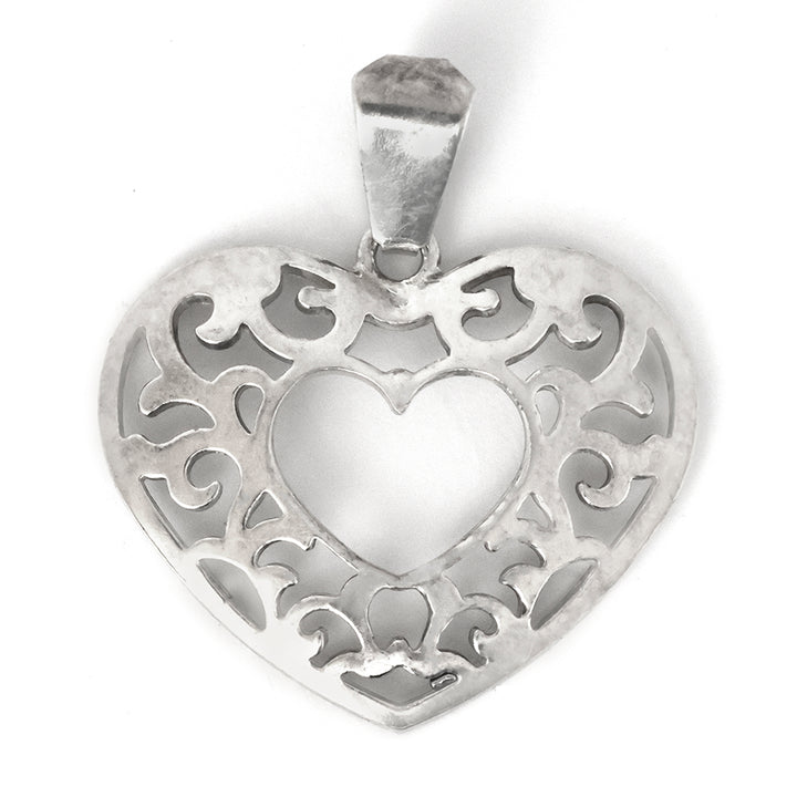 Silver heart-shaped pendant with intricate designs on a white background