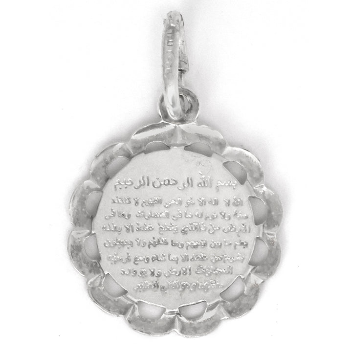Silver pendant with engraved text on a white background