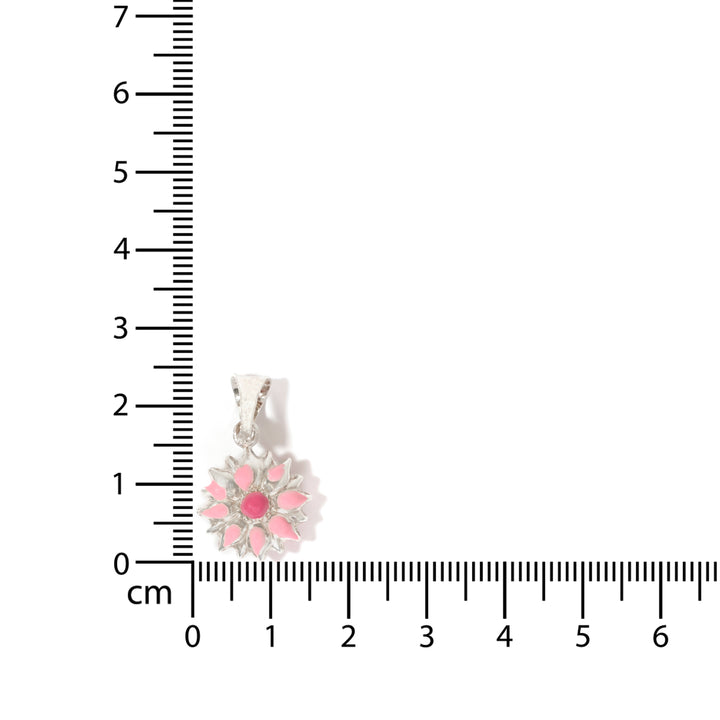 Floral pendant with pink accents on a ruler for scale