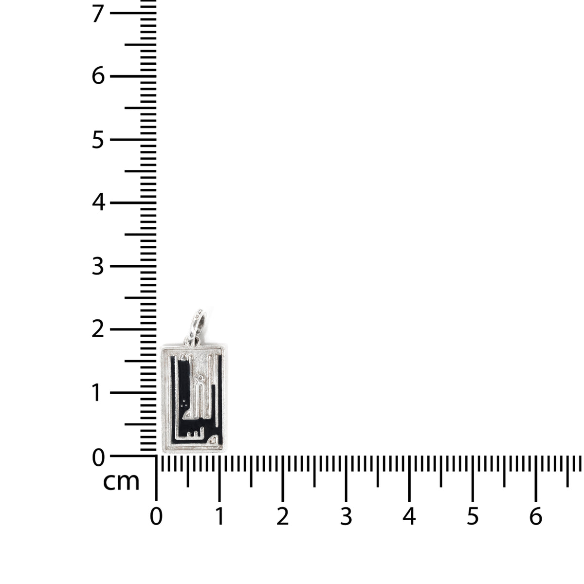 Small rectangular pendant next to a ruler on a white background