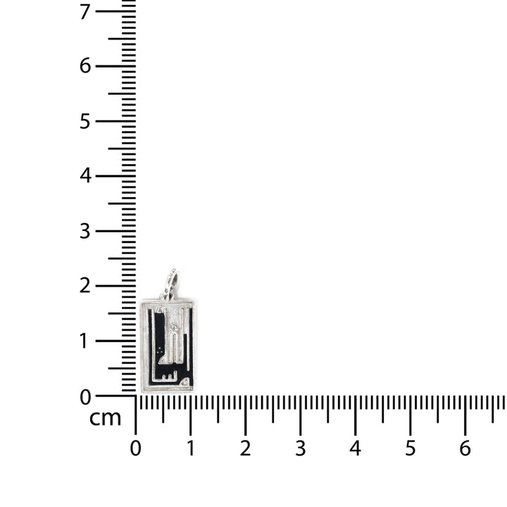 Small rectangular pendant next to a ruler on a white background