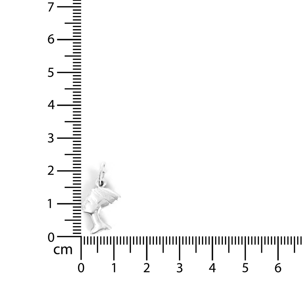 White butterfly charm on a ruler for scale