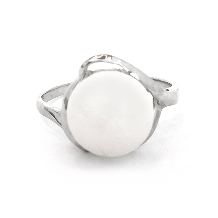 Silver ring with a white circular stone on a white background
