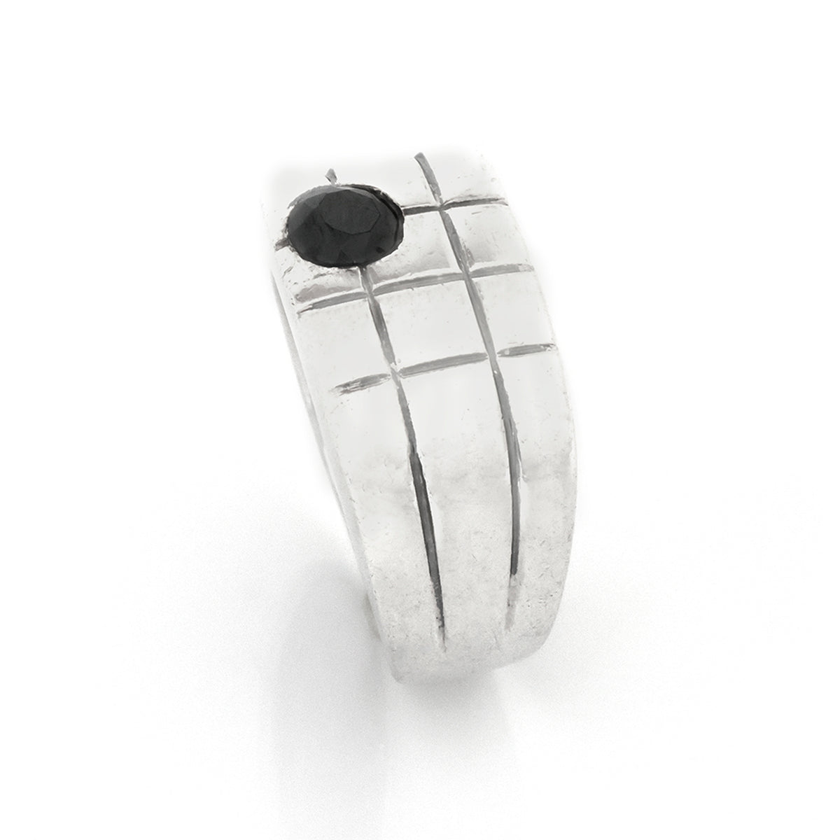 Silver ring with a black stone on a white background