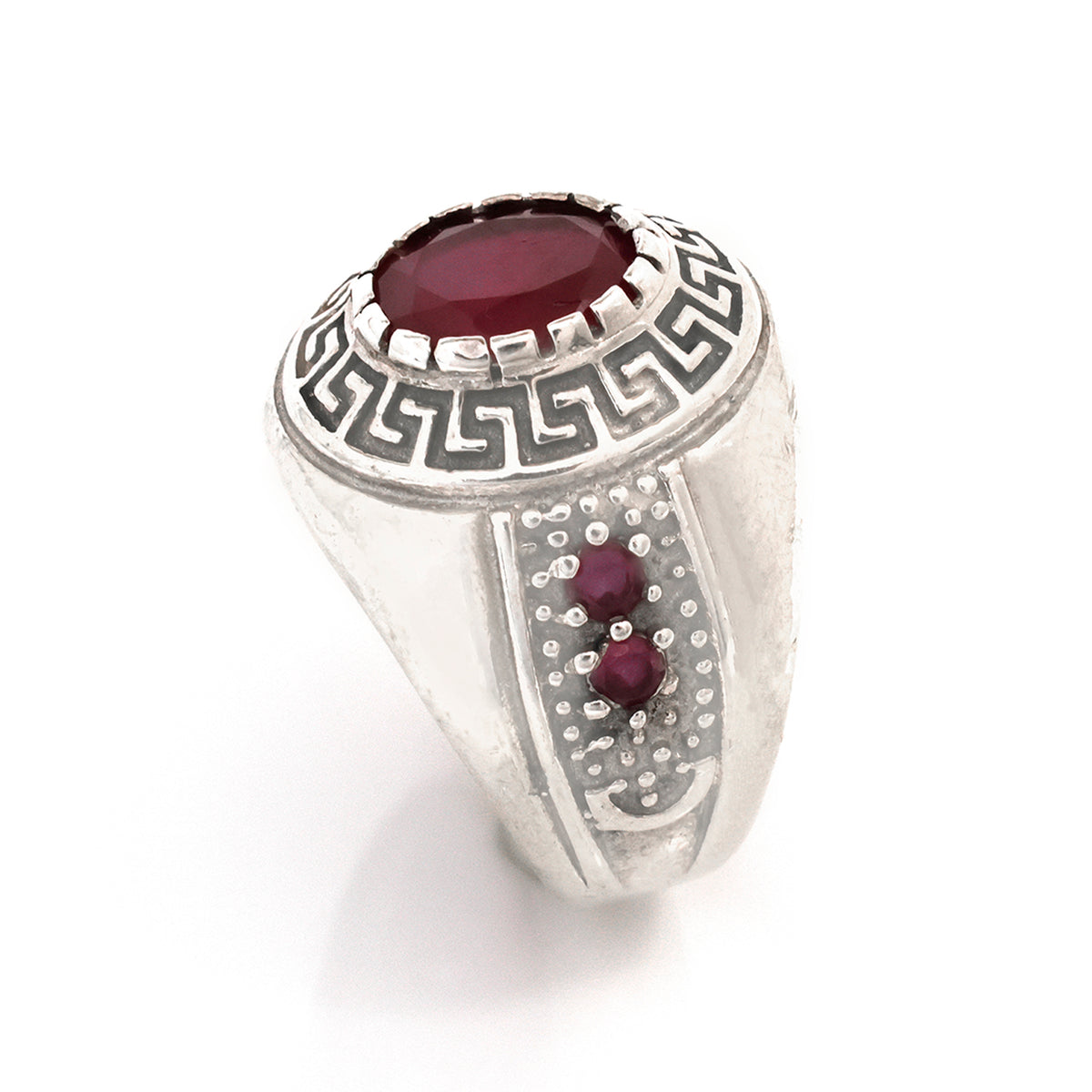 Silver ring with a red gemstone on a white background