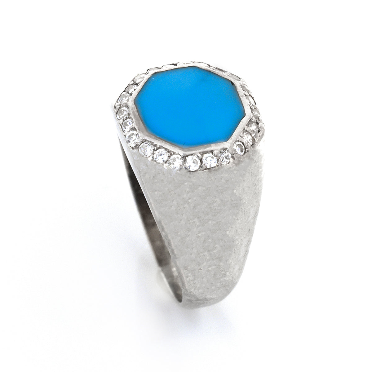 Silver ring with a blue gemstone and clear stones on a white background