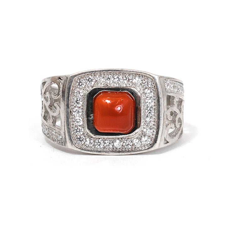 Silver ring with a red stone on a white background