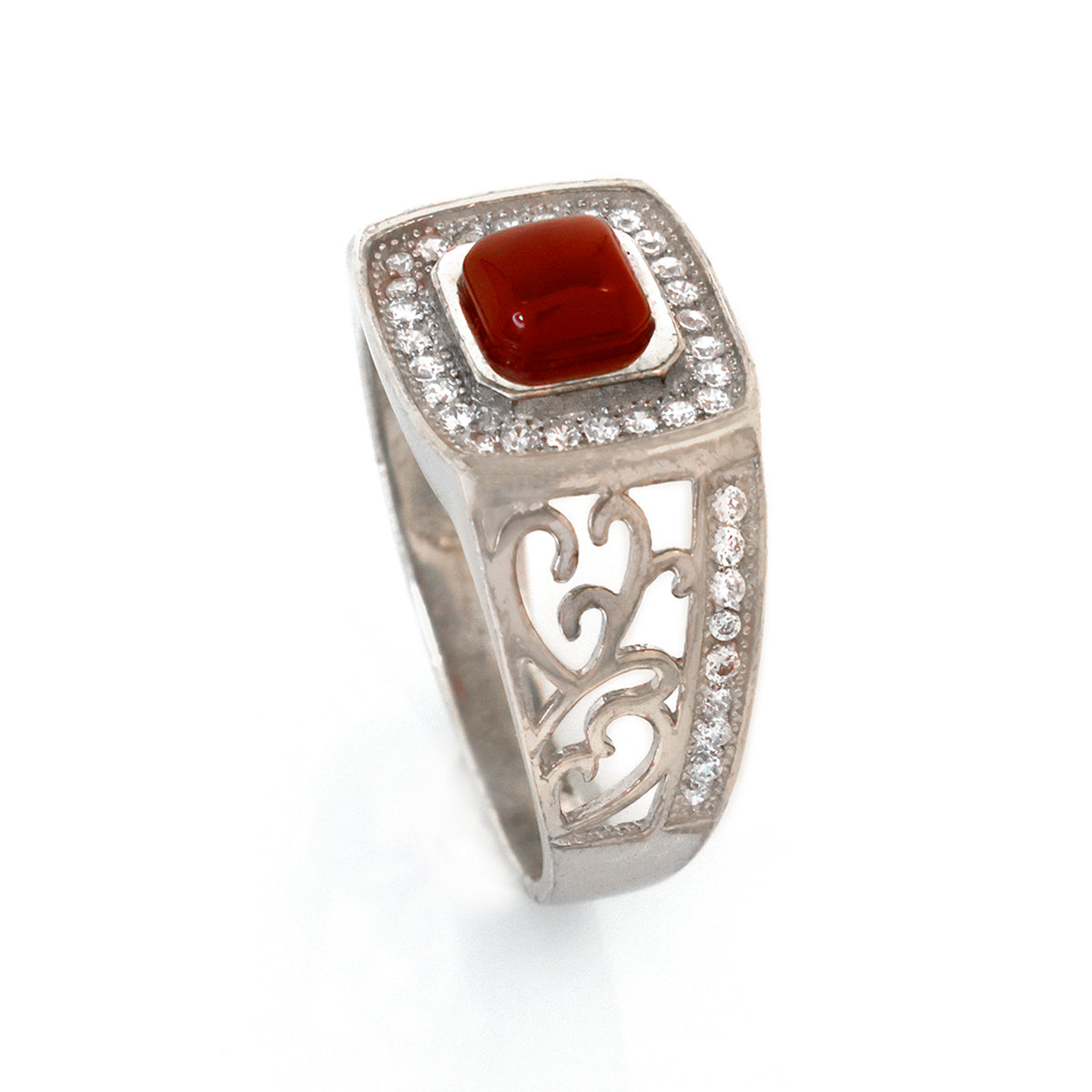 Silver ring with a red stone and diamond accents on a white background
