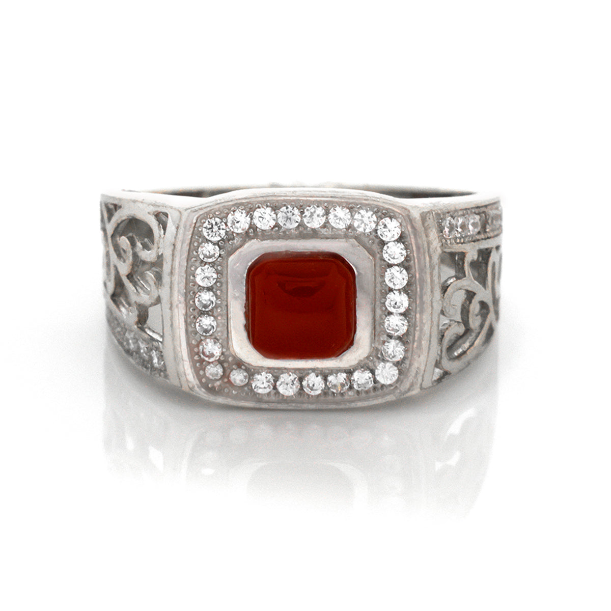 Silver ring with a red stone and clear gemstones on a white background