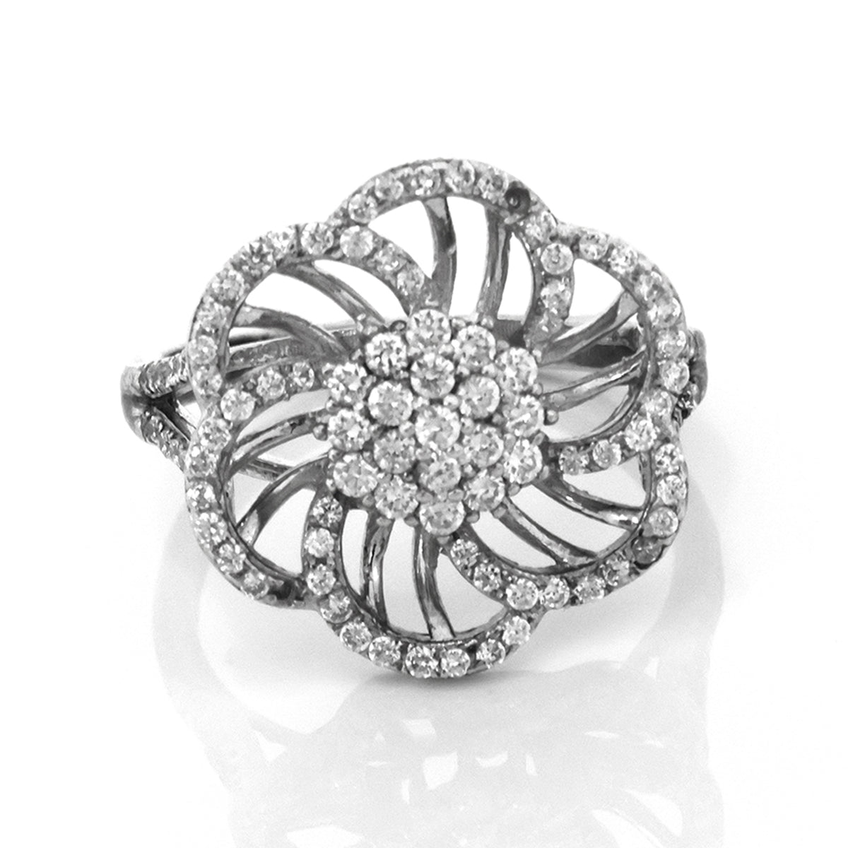 Silver ring with diamond flower design on a white background