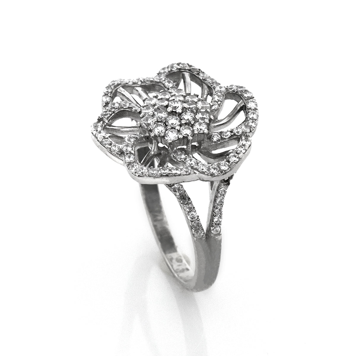 Silver ring with diamond accents on a white background
