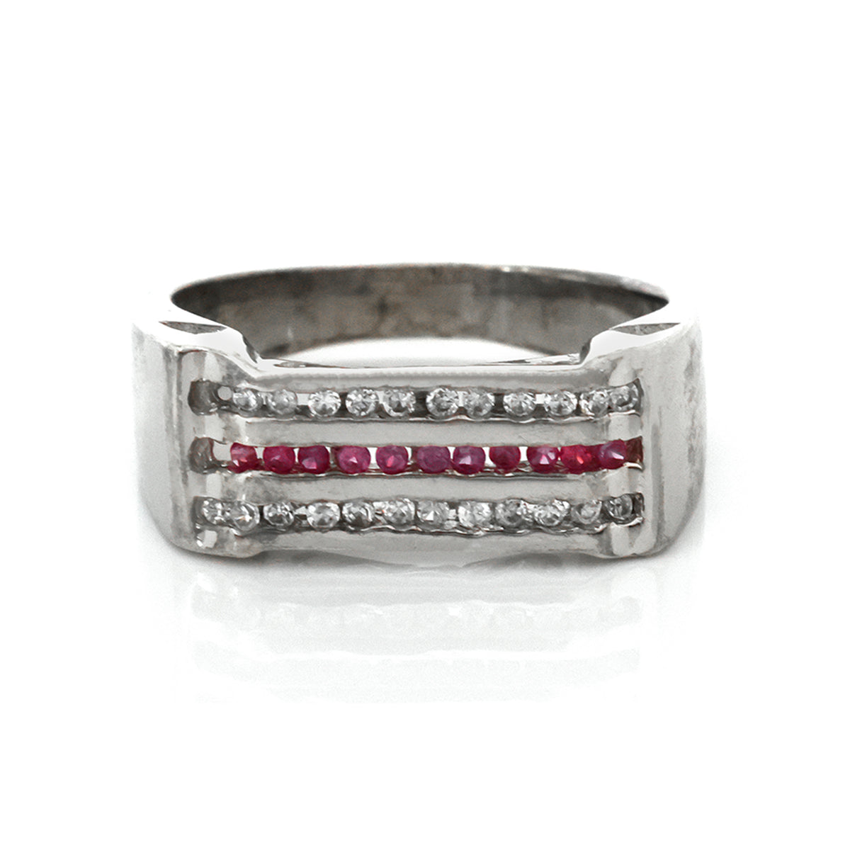 Silver ring with red gemstones on a white background