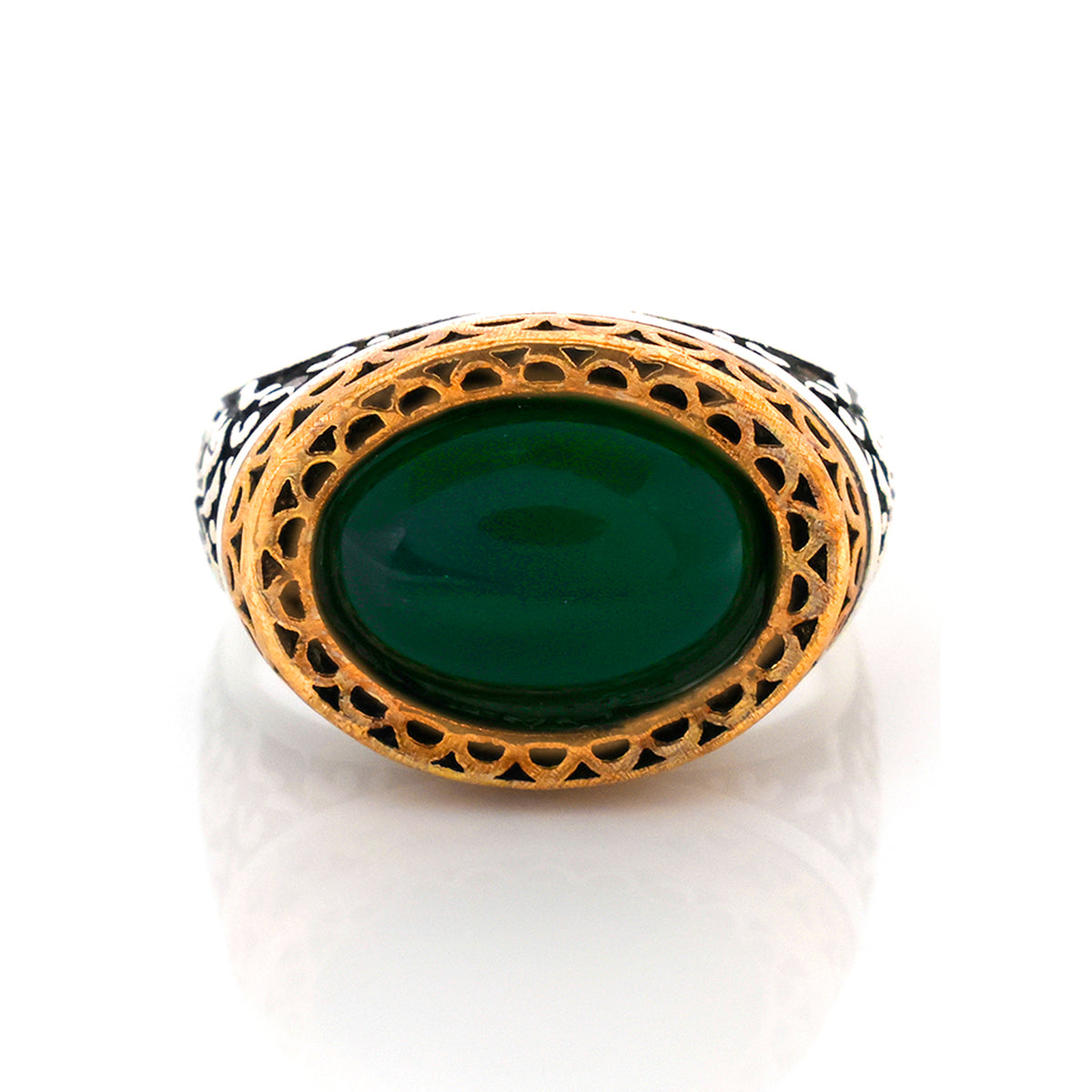 Gold ring with green stone on a white background
