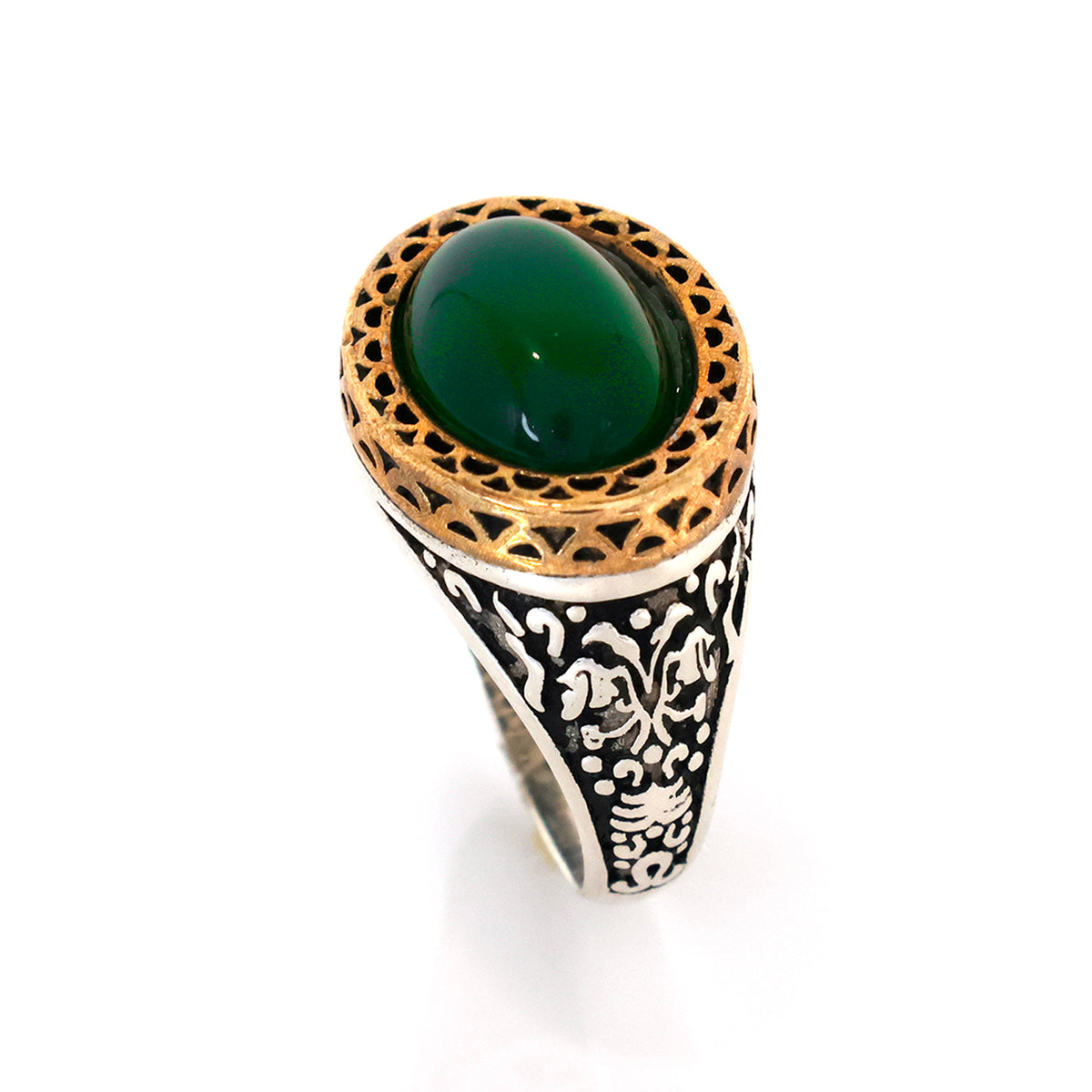 Ring with green stone and intricate design on a white background