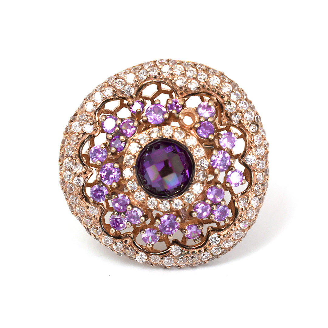 Jewelry item with purple gemstone and rose gold setting on a white background