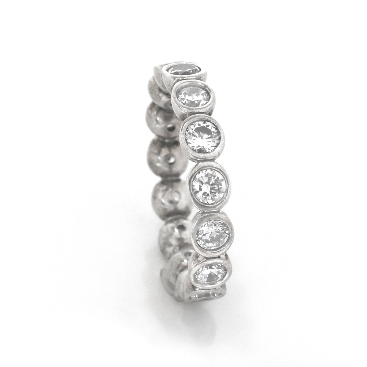 Silver ring with embedded diamonds on a white background