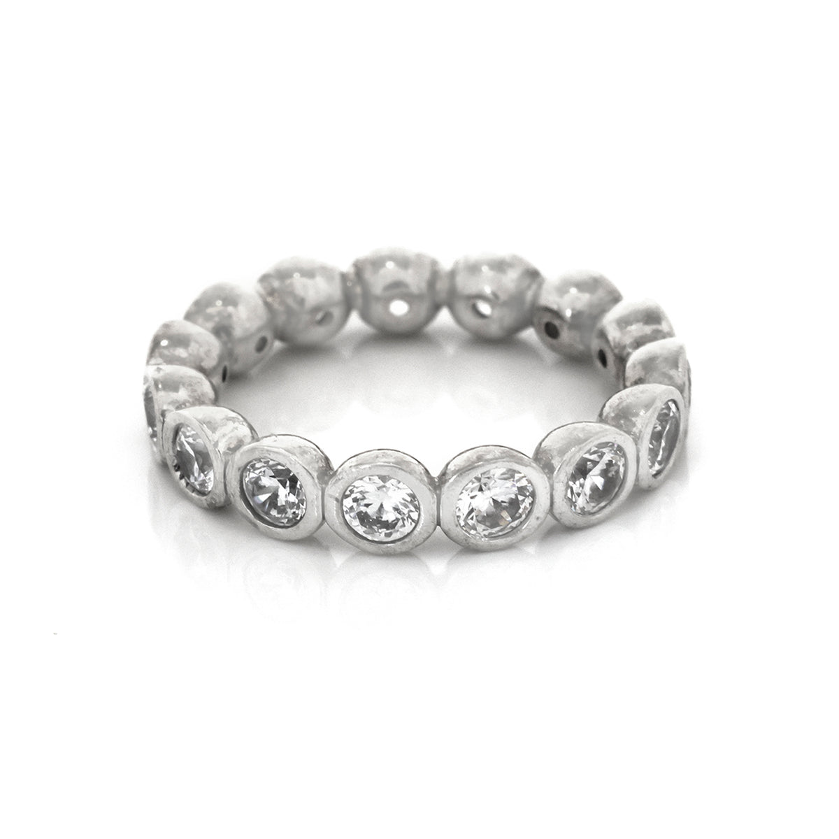 Silver ring with embedded stones on a white background