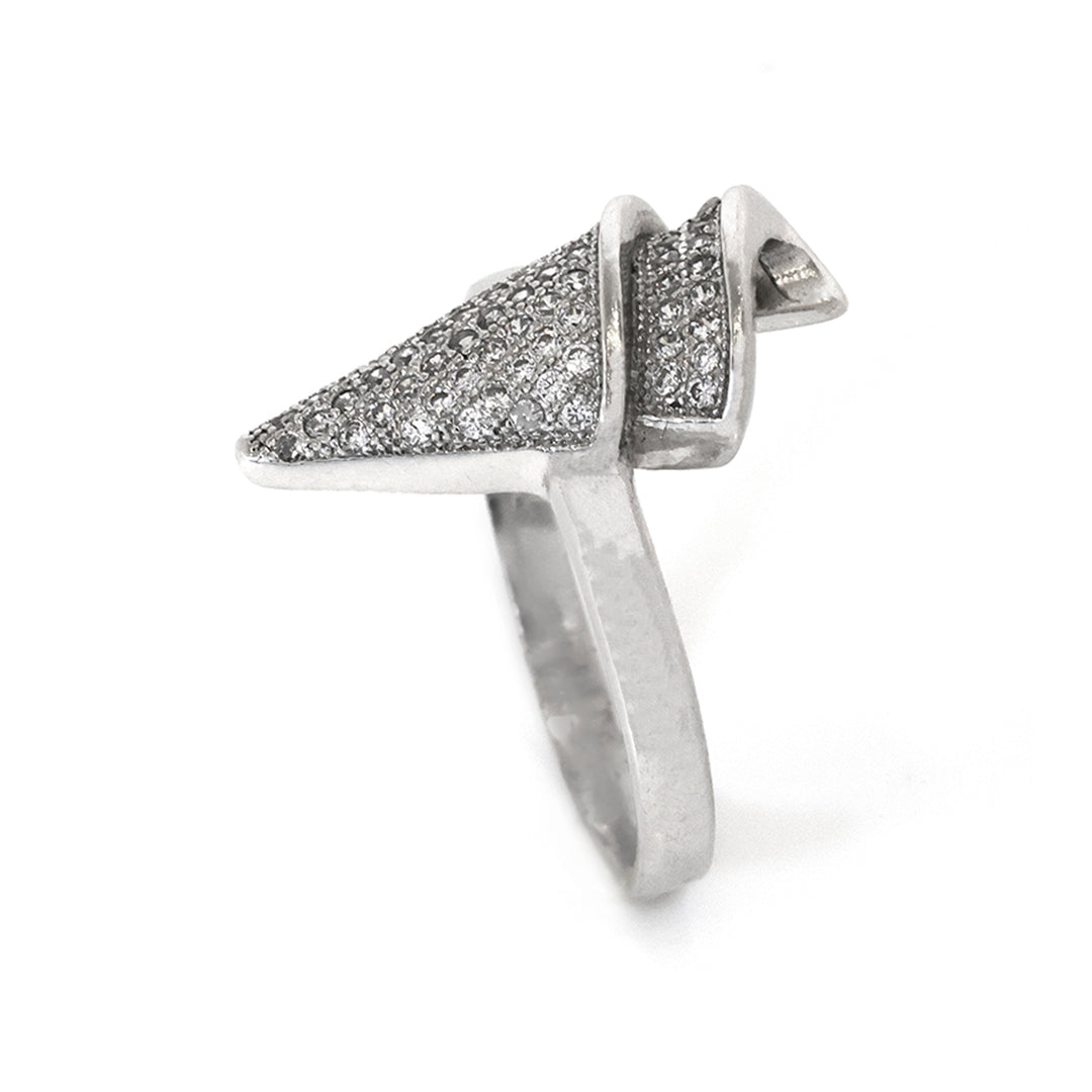 Silver ring with pyramid-shaped top on a white background