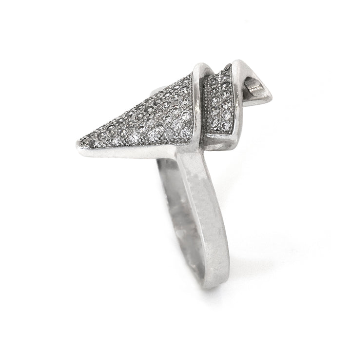 Silver ring with pyramid-shaped top on a white background