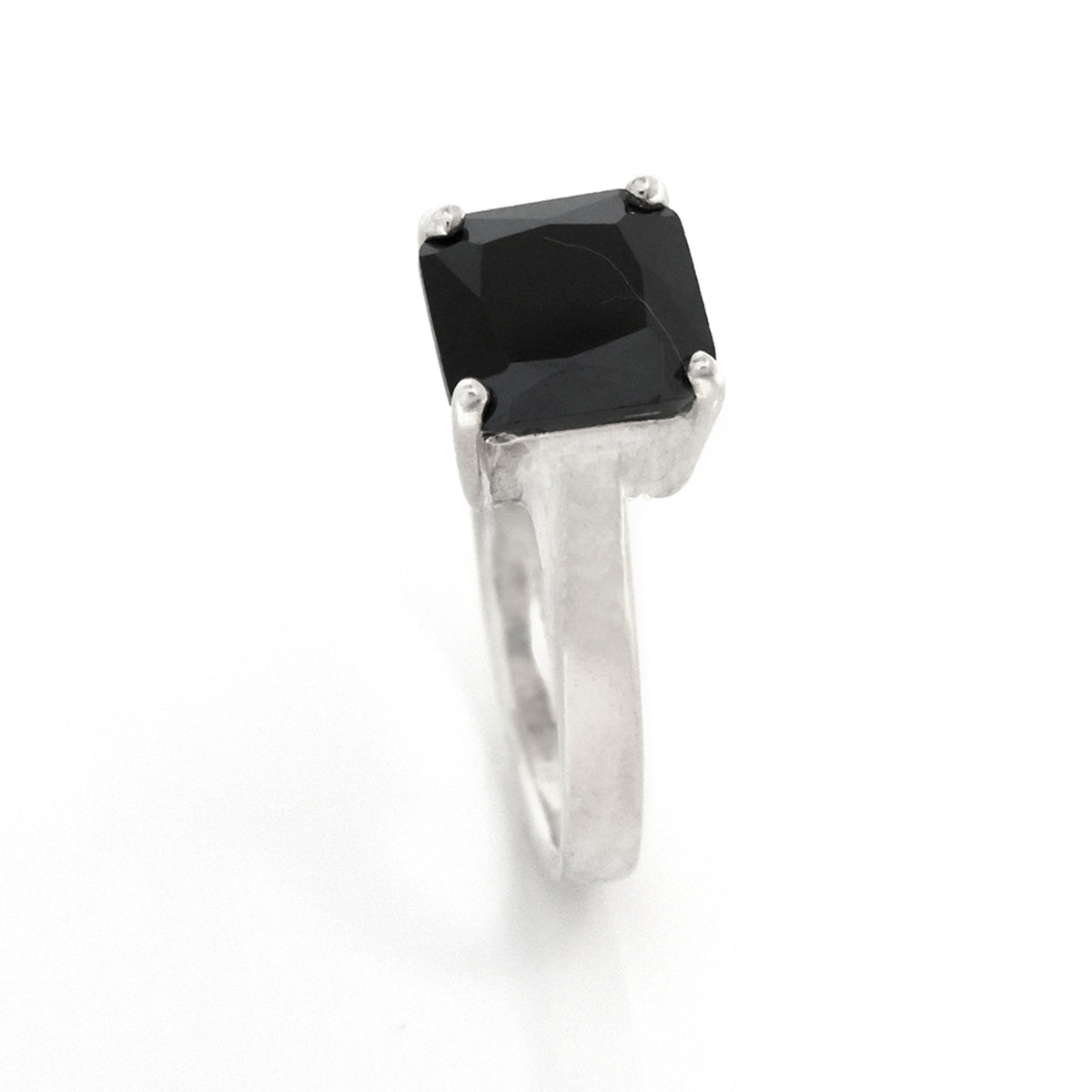 Silver ring with a black gemstone on a white background