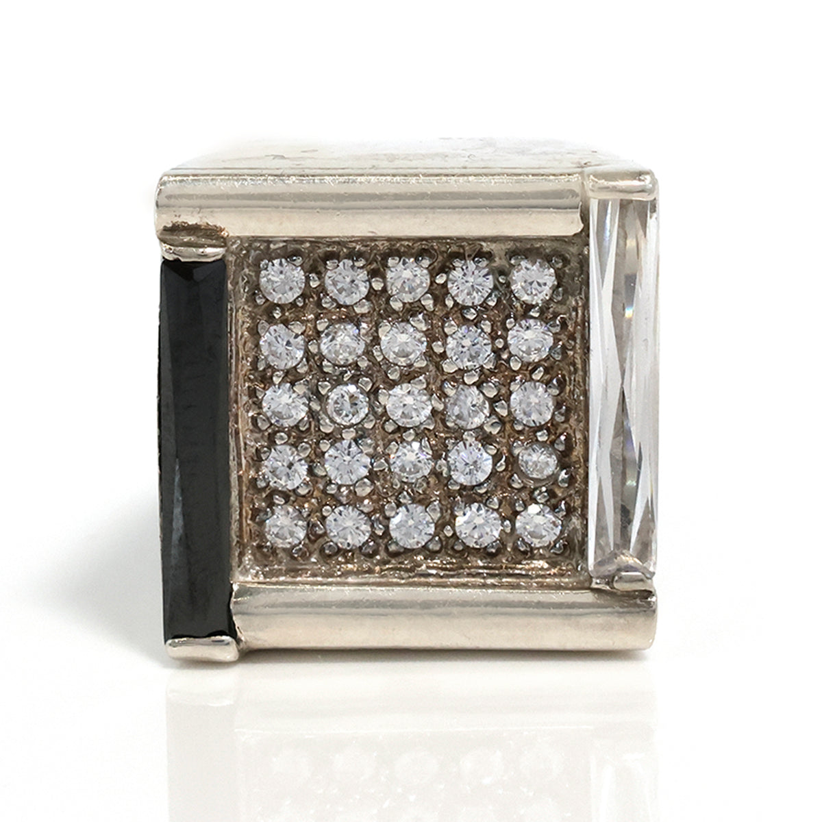 Silver cube charm with embedded diamonds on a white background
