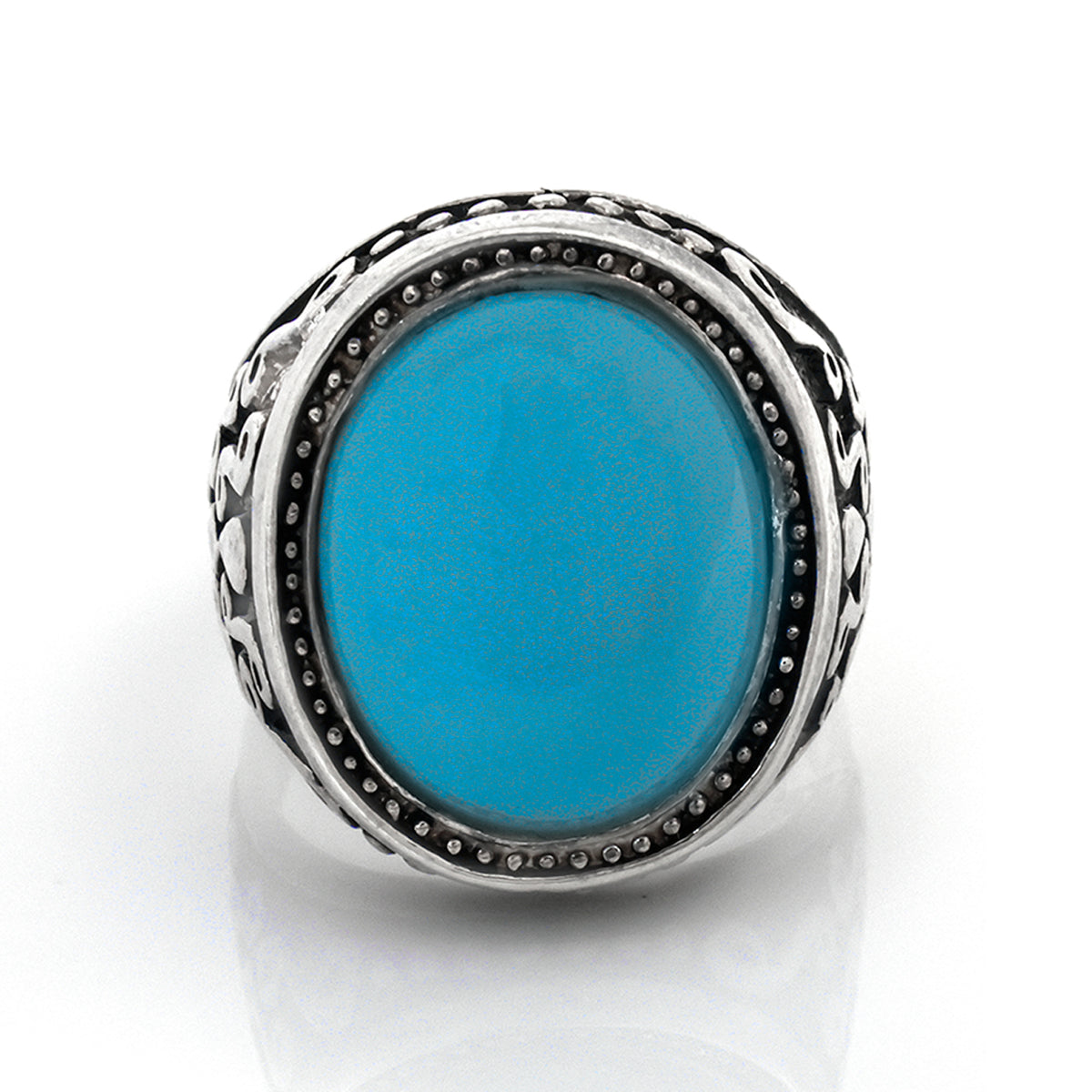 Silver ring with a blue stone on a white background