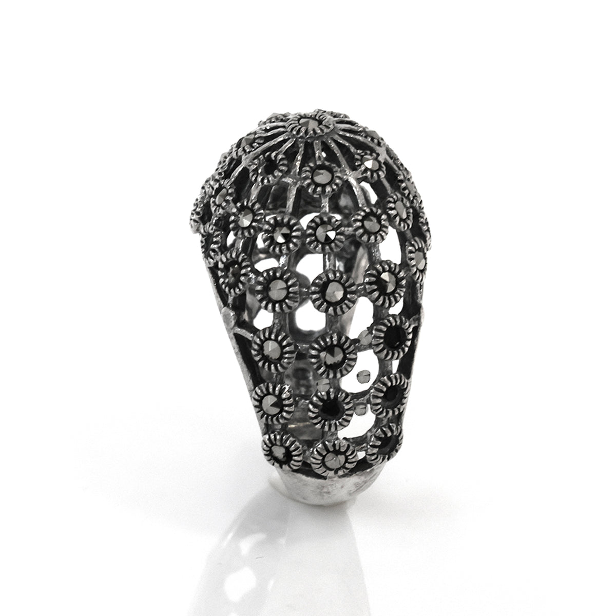 Decorative metal head with intricate designs on a white background