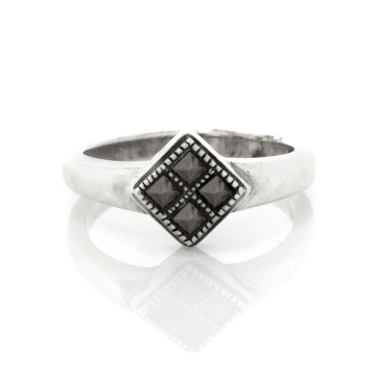 Silver ring with a geometric black stone design on a white background