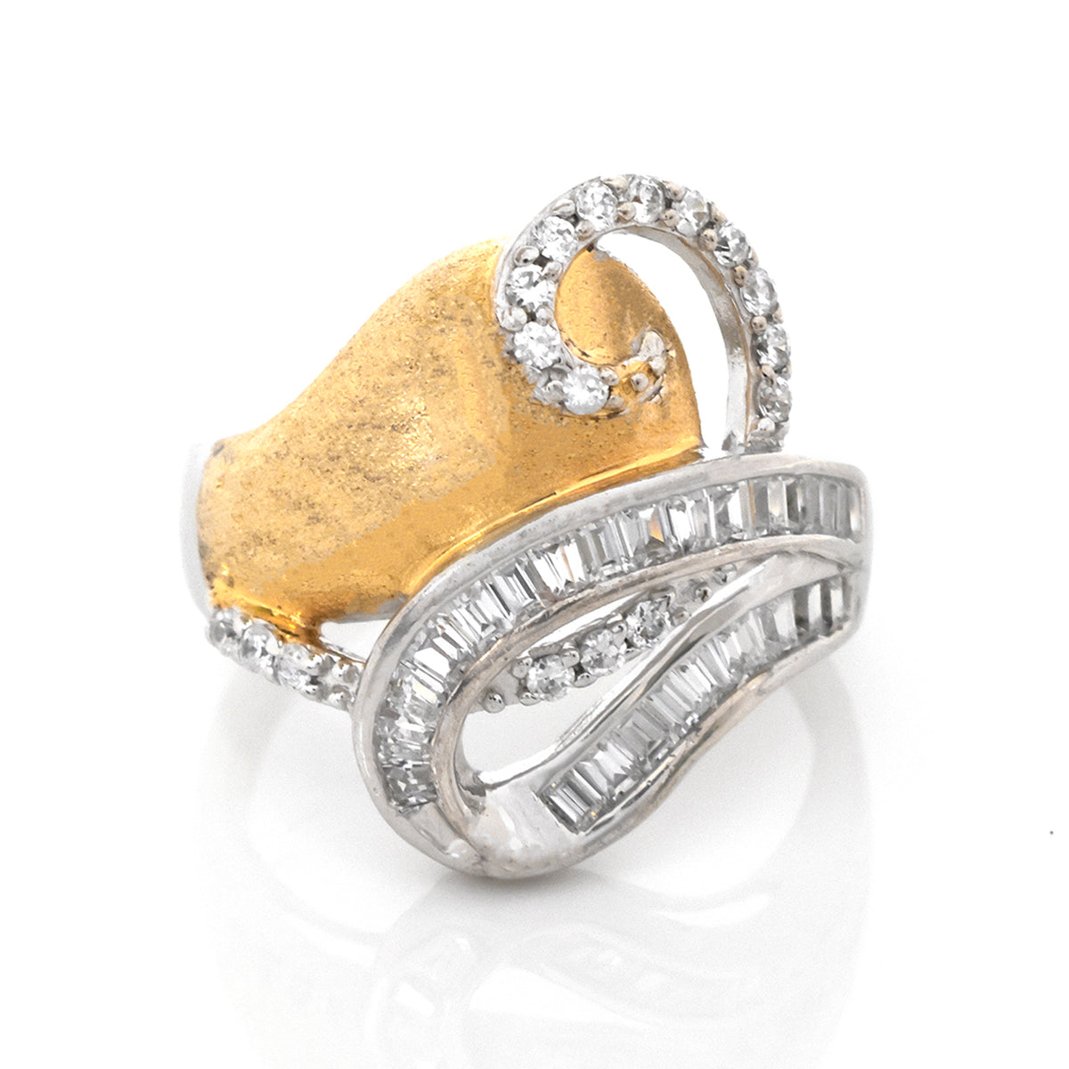 Gold and silver ring with diamond accents on a white background