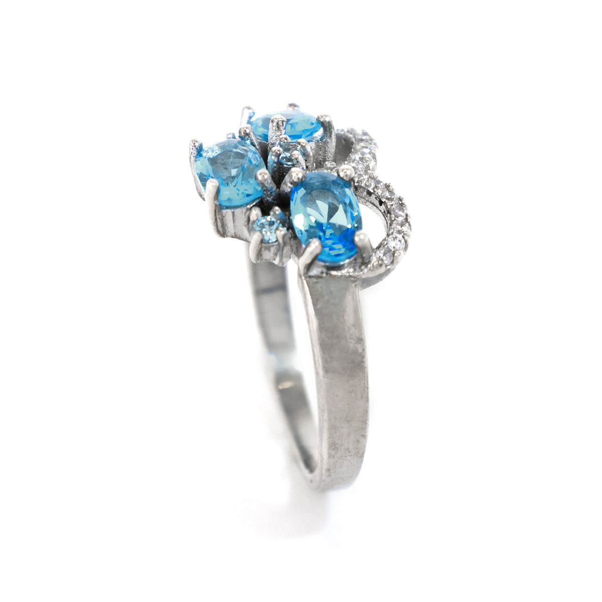 Silver ring with blue gemstones on a white background