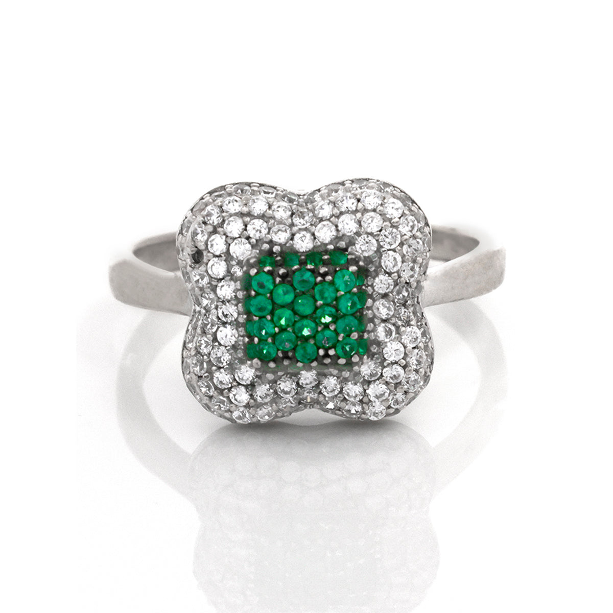 Silver ring with green gemstone and clear stones on a white background