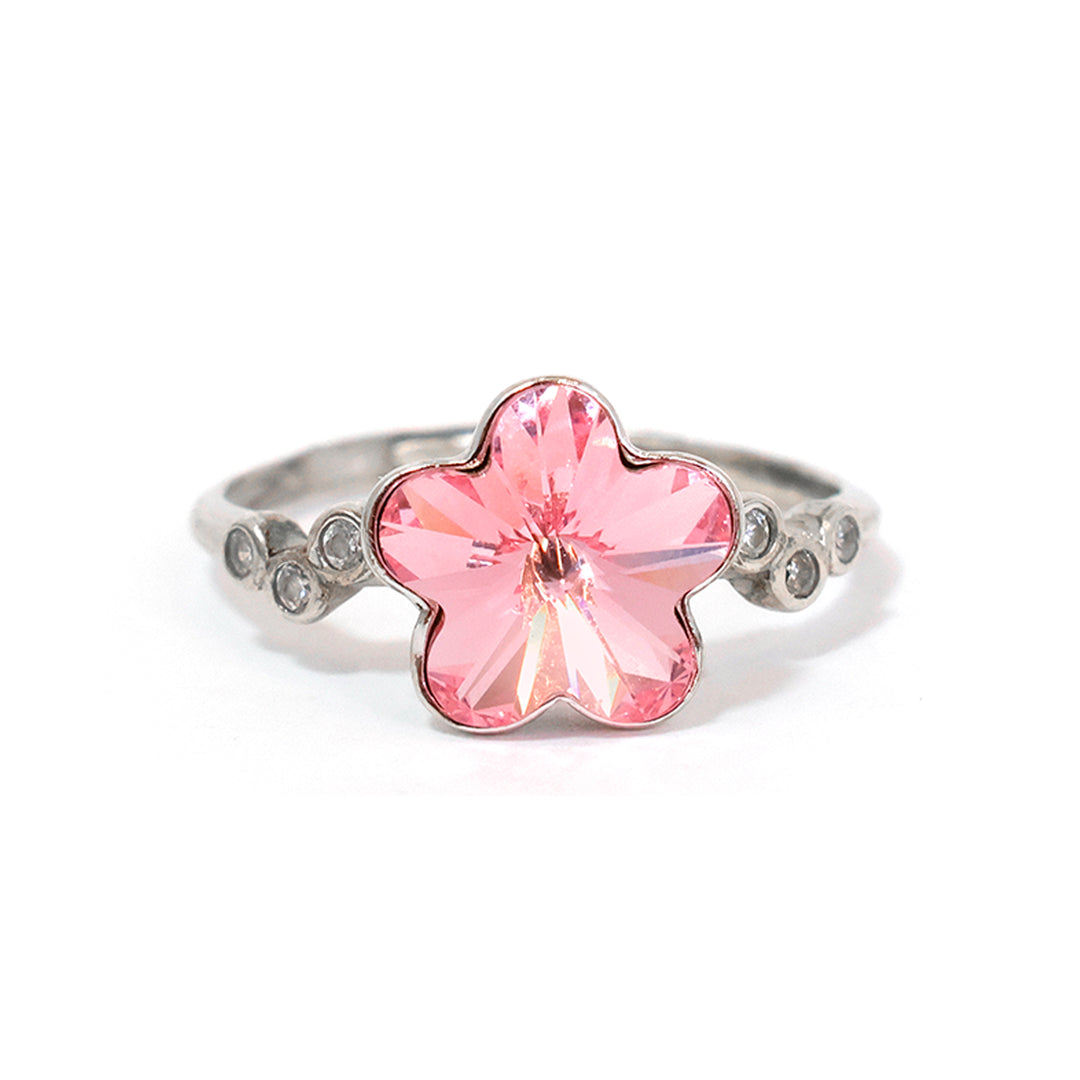 Ring with a pink flower-shaped gemstone on a white background