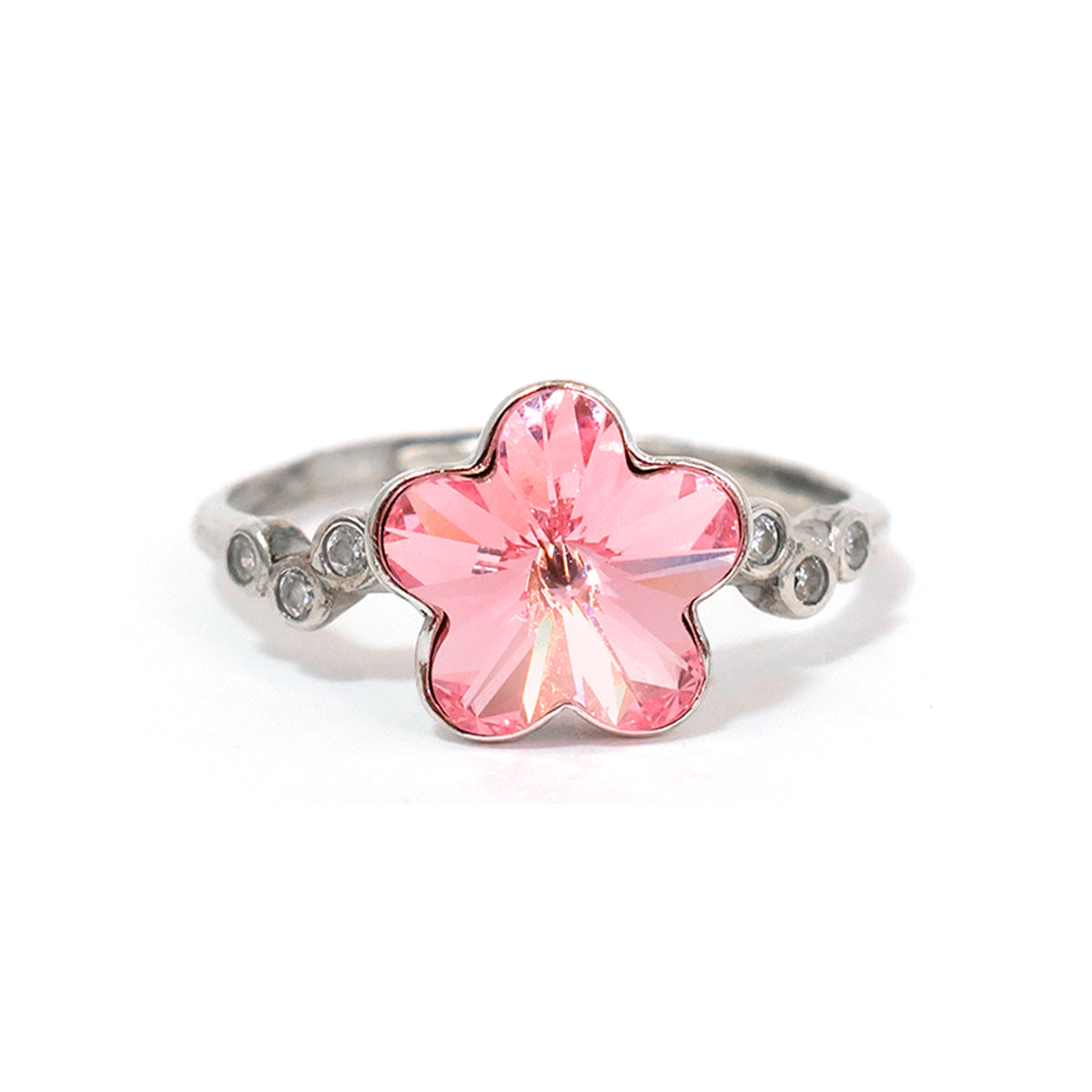 Ring with a pink flower-shaped gemstone on a white background