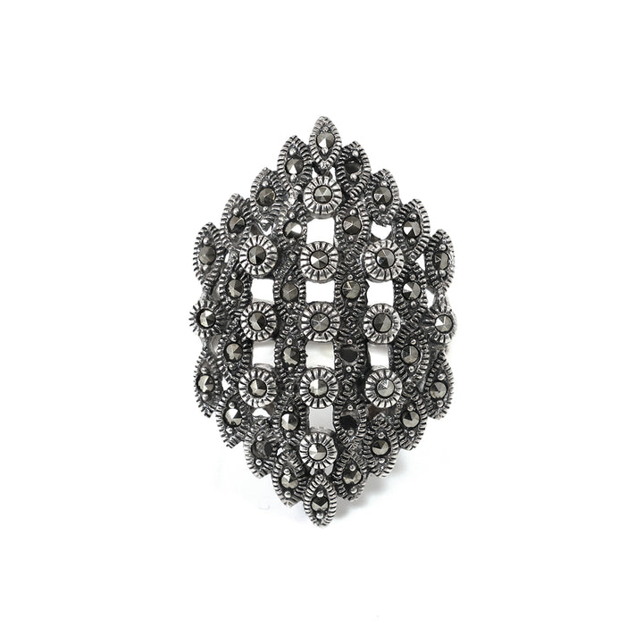 Decorative brooch with intricate design on a white background