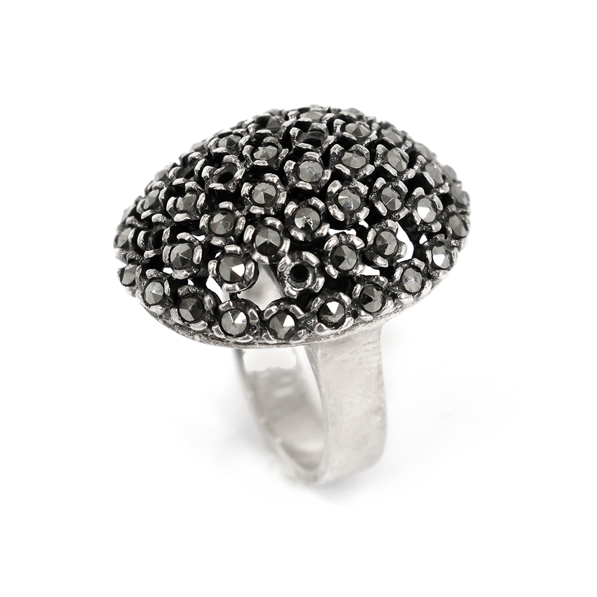 Silver ring with black gemstones on a white background