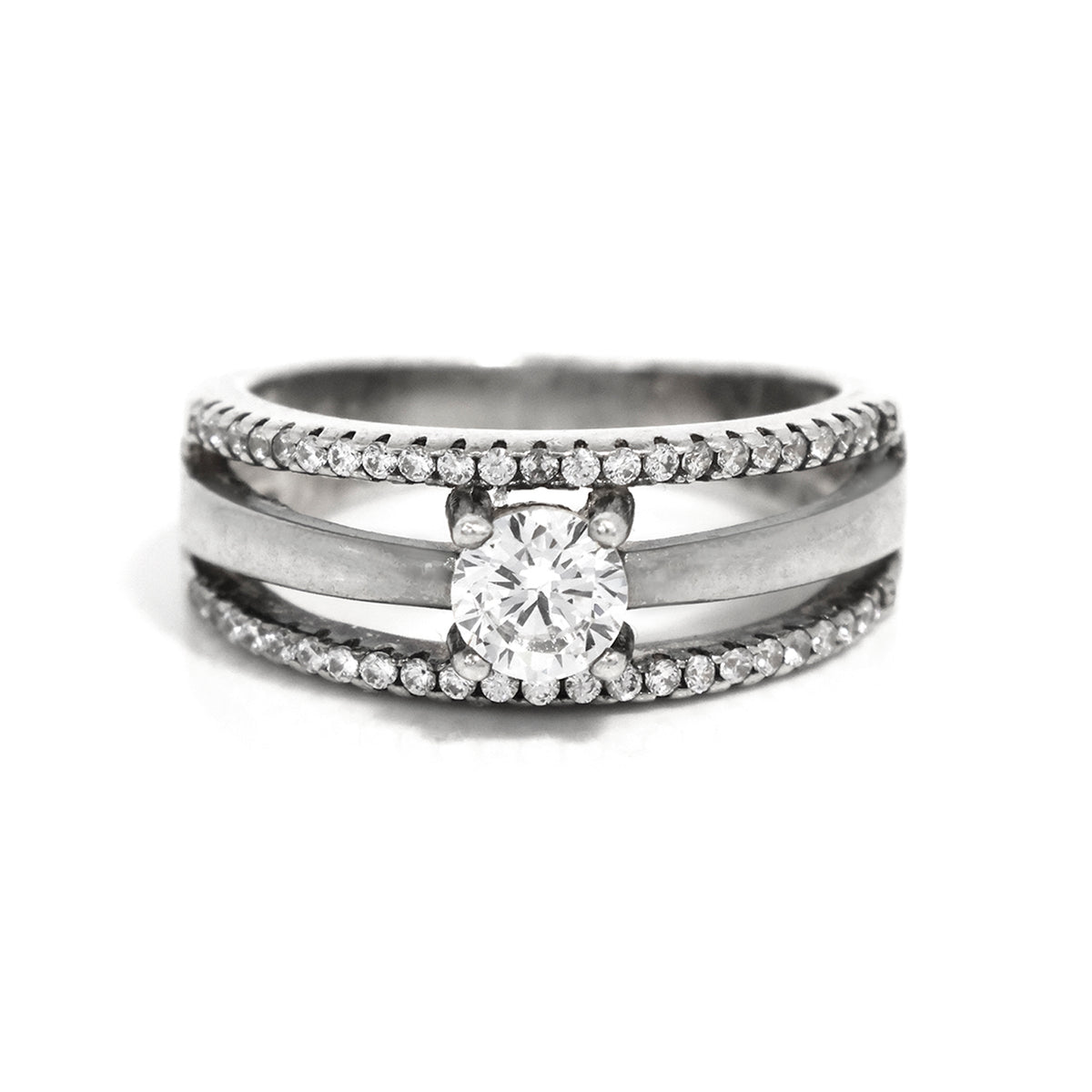 Silver ring with a central diamond and smaller diamonds on a white background