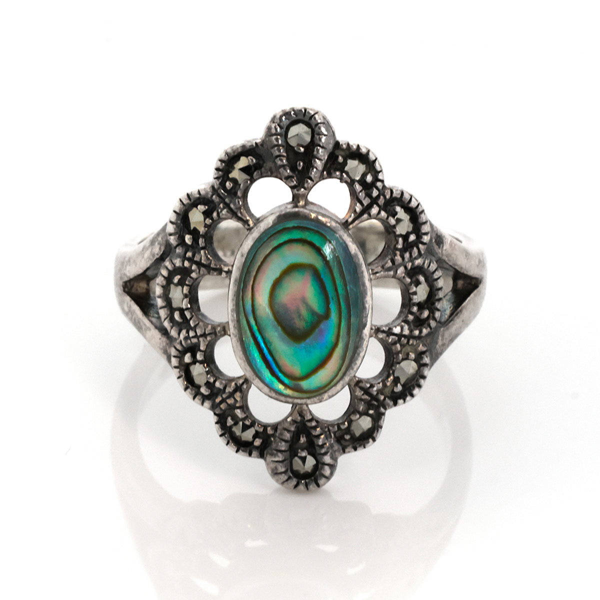 Silver ring with a colorful gemstone on a white background
