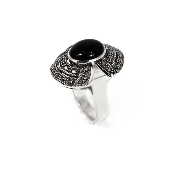 Silver ring with a black gemstone on a white background