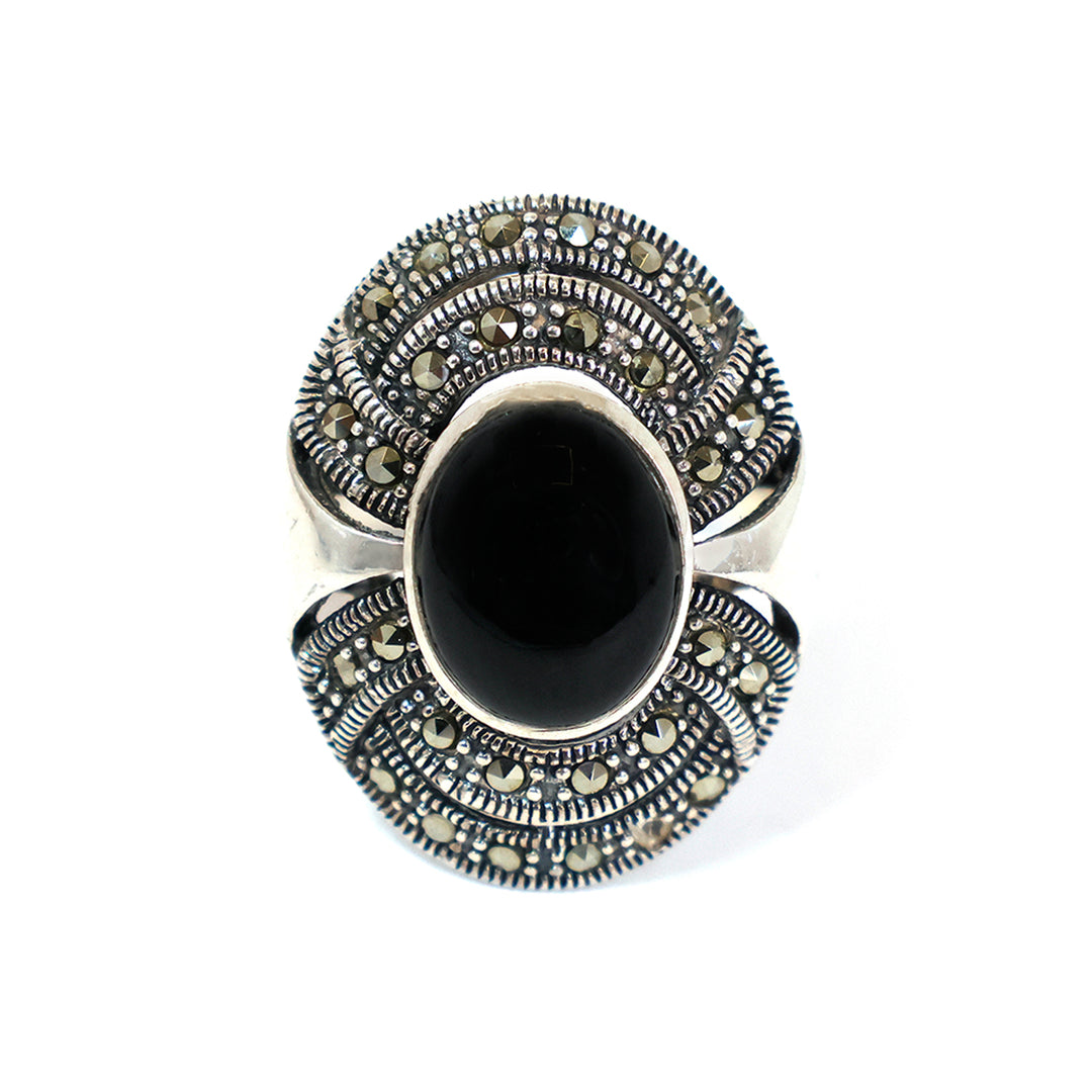 Silver ring with black gemstone on a white background
