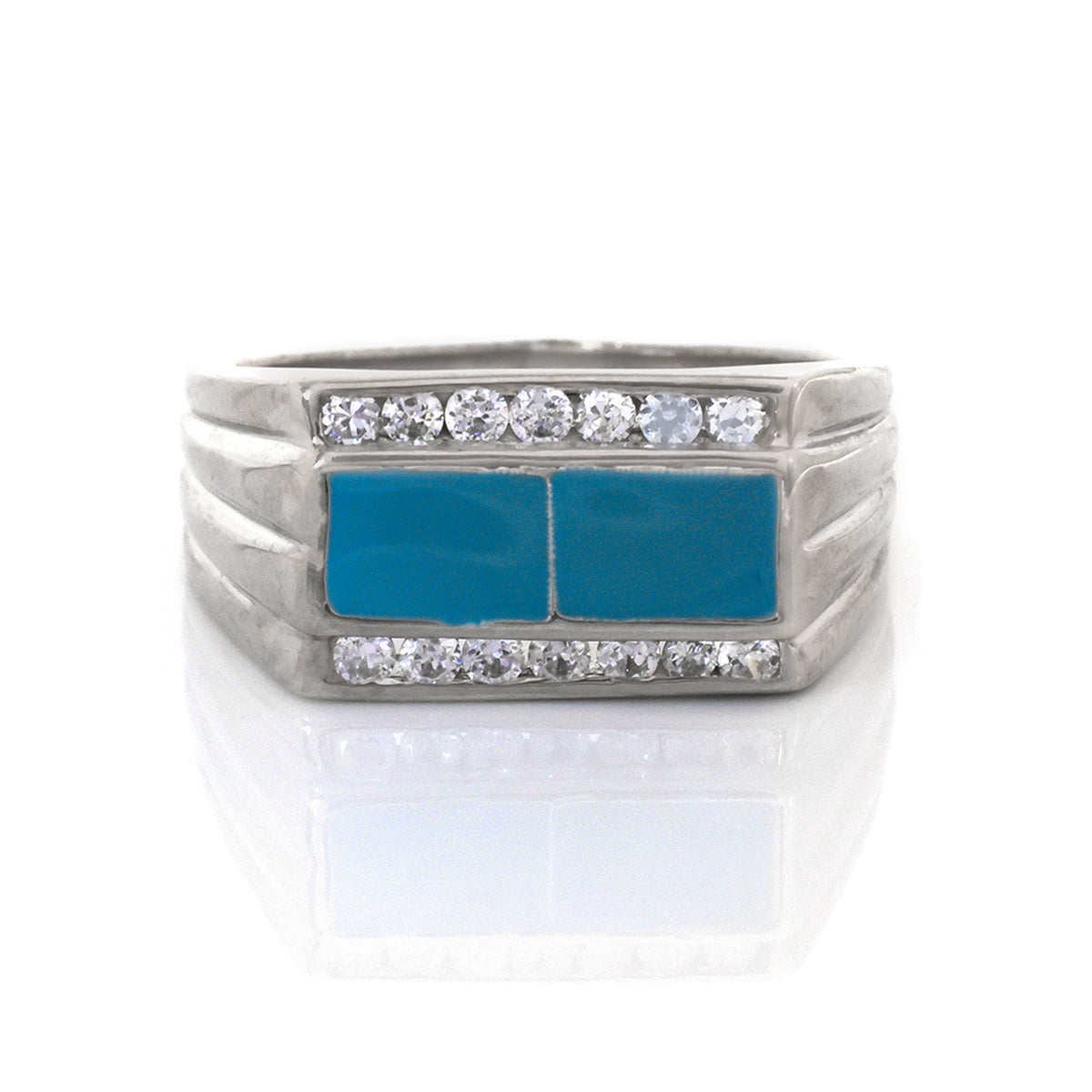 Silver ring with blue stones and clear gemstones on a white background