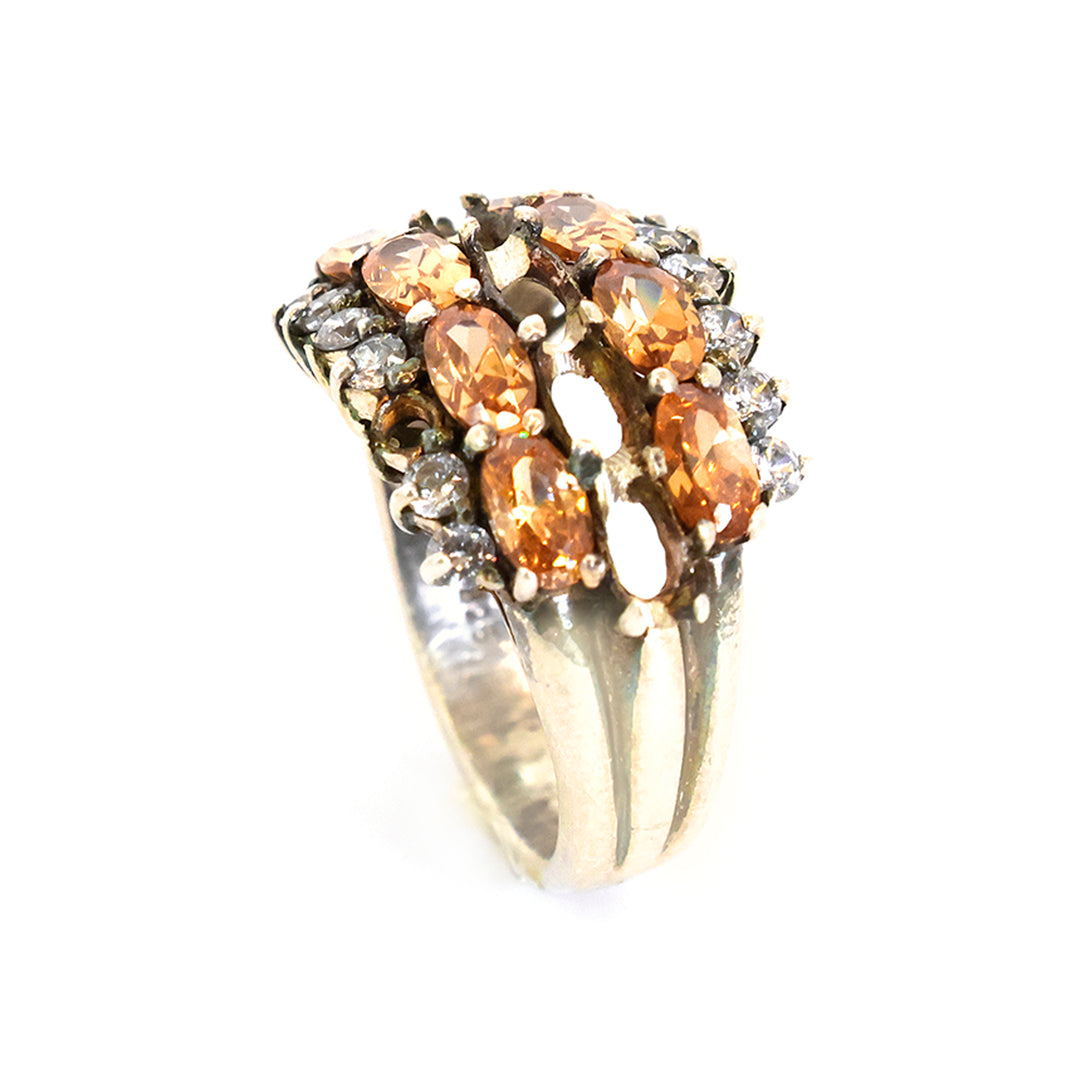 Gold ring with brown gemstones on a white background